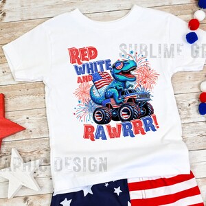 May include: White t-shirt with a red, white, and blue dinosaur monster truck graphic. The dinosaur is wearing sunglasses and holding an American flag. The text "Red White and Rawrrr!" is printed on the shirt.