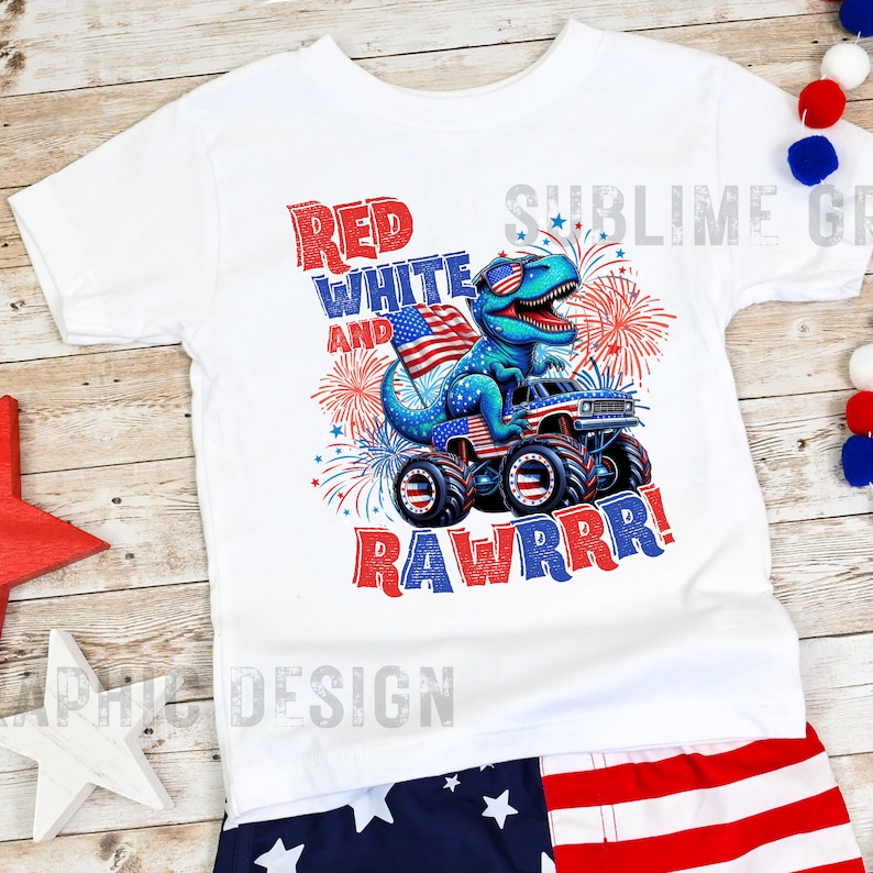 May include: White t-shirt with a red, white, and blue dinosaur monster truck graphic. The dinosaur is wearing sunglasses and holding an American flag. The text "Red White and Rawrrr!" is printed on the shirt.