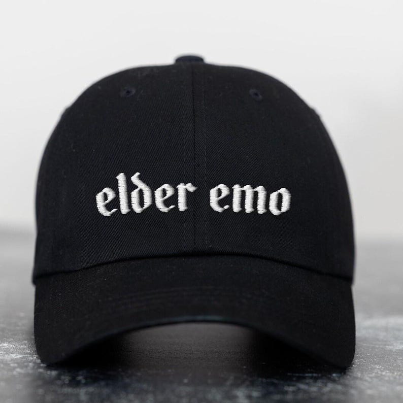 May include: Black baseball cap with white embroidered text that reads "elder emo".