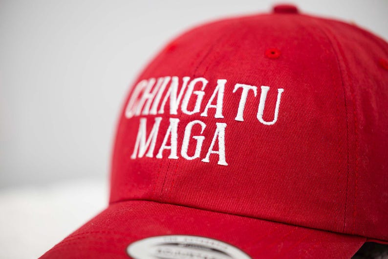 May include: Red baseball cap with white embroidered text that reads "CHINGATU MAGA".