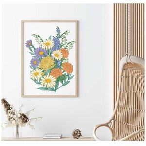 May include: A framed print of a colorful bouquet of flowers, including daisies, carnations, and chrysanthemums, in shades of yellow, orange, purple, and blue.