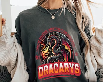 May include: A gray sweatshirt with a black and red dragon graphic and the text "They're beautiful, aren't they? And dangerous." and "Dracarys" in red.