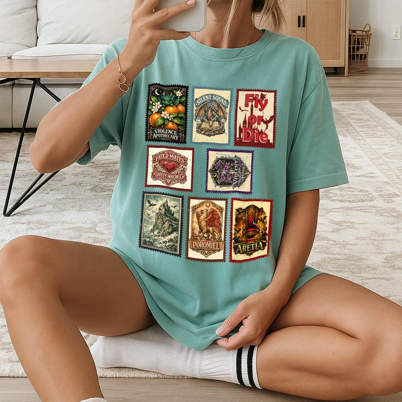 May include: A teal-colored t-shirt featuring nine postage stamp-style graphics. The stamps depict various illustrations, including oranges, a dragon, and a castle. Text on the stamps includes "Violence Apothecary," "Silent Squad," and "Fly or Die."