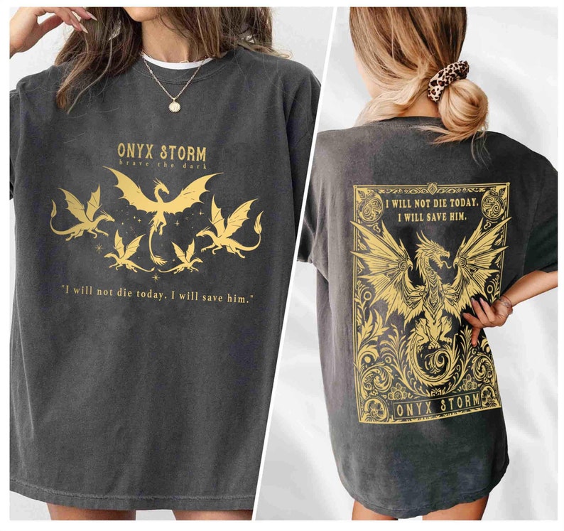 May include: A black t-shirt with a gold dragon graphic and the text "ONYX STORM brave the dark" on the front. The back of the shirt features a larger gold dragon graphic with the text "I WILL NOT DIE TODAY. I WILL SAVE HIM." and "ONYX STORM" at the bottom.