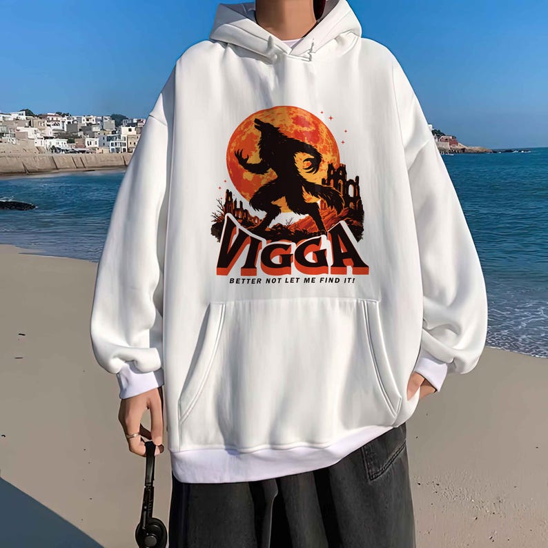 May include: White hooded sweatshirt with a front pocket and a graphic of a werewolf in front of a full moon. The word "VIGGA" is printed in orange and black, with the text "BETTER NOT LET ME FIND IT!" below.