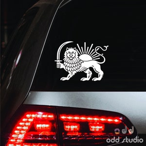 May include: White vinyl sticker of the Lion and Sun, the national emblem of Iran, on a black car window.