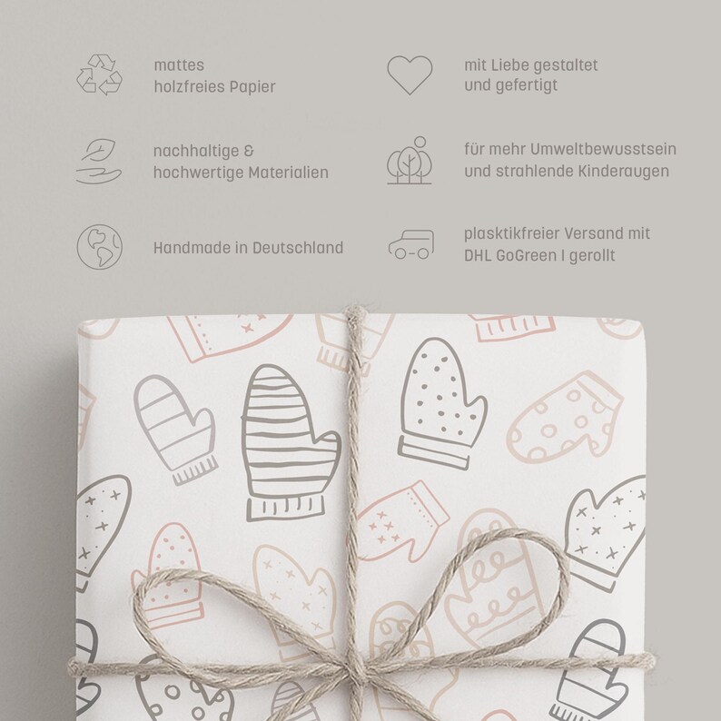 May include: White wrapping paper with a pattern of mittens in gray and light pink, tied with twine. The paper is decorated with various mitten designs, creating a cozy and festive look. The paper is perfect for wrapping gifts.