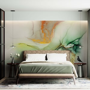 May include: A bedroom with a green and gold abstract wall mural, a bed with white linens and a green bedspread, two black pendant lights, and two side tables with black birds.