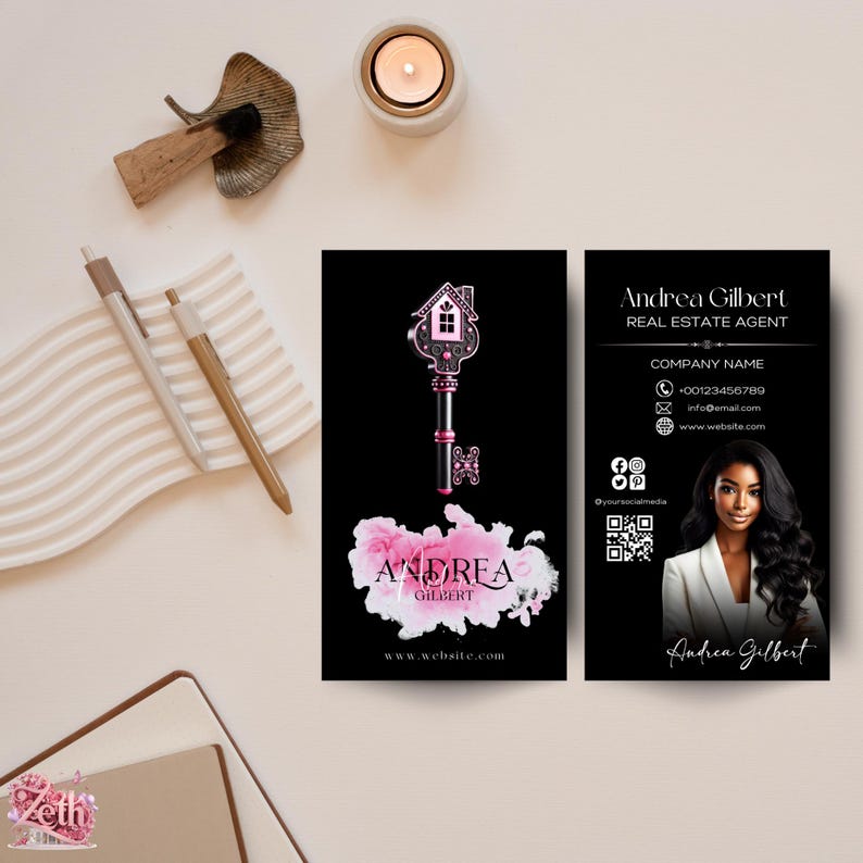 May include: Black and white business card with a pink and black key design and the text "Andrea Gilbert, Real Estate Agent". The card also includes a QR code, contact information, and a photo of a woman with dark hair.