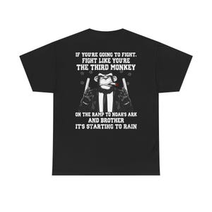 May include: Black t-shirt with a white graphic of a monkey wearing a suit and holding two guns. The text reads "If you're going to fight, fight like you're the third monkey on the ramp to Noah's ark and brother it's starting to rain."