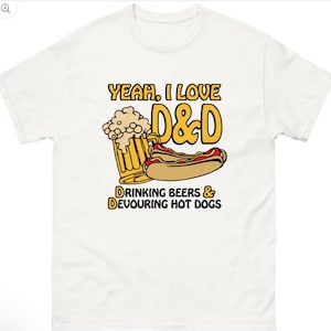 May include: White t-shirt with a graphic that reads "Yeah, I love D&D" in yellow and black. The graphic includes a beer mug, a hot dog, and the text "Drinking Beers & Devouring Hot Dogs."