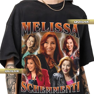 May include: Black t-shirt featuring a graphic print of Melissa Schemmenti, a reality TV personality. The graphic is a collage of images of Melissa in various poses, with the text "Melissa Schemmenti" in large, bold lettering.