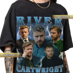 May include: Black t-shirt featuring a graphic print of four men's faces. The text "River Cartwright" is printed in blue and white lettering below the faces.