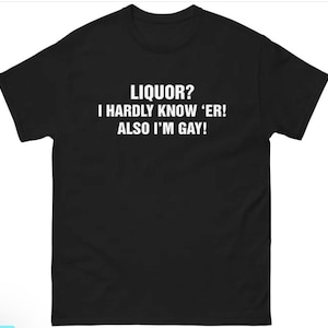以下が含まれることがあります： 「LIQUOR？I HARDLY KNOW 'ER！ALSO I'M GAY！」と白い文字で書かれた黒いTシャツ。半袖のクルーネックです。