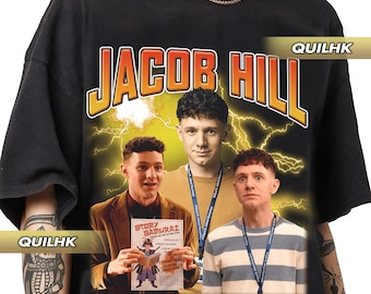 May include: Black t-shirt featuring a graphic print of three men. The graphic includes the text "JACOB HILL" in large, yellow letters with lightning bolts. The men are wearing blue and white striped shirts and holding a book with the text "Story Samurai" on the cover. The text "I'M NOT THE ONE OR THE TWO, SO PLEASE SEND MY KID HOME AT THREE. TRY JESUS, DON'T TRY ME" is printed below the graphic.