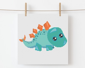 May include: A cross-stitch pattern featuring a cute blue dinosaur with orange spikes and big eyes. The dinosaur is on a white background.