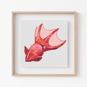 May include: A cross-stitch pattern of a red squid with pink fins. The squid is facing the left side of the image.