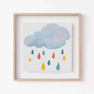 May include: A framed cross-stitch design featuring a blue cloud with raindrops in shades of blue, yellow, and orange.