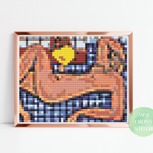 May include: A cross stitch pattern featuring a nude figure lying on a blue and white checkered background. The figure is depicted in a relaxed pose with a yellow object in the background.