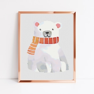 May include: A white polar bear wearing a red and orange striped scarf. The bear is sitting down and looking to the right. The image is in a gold frame.