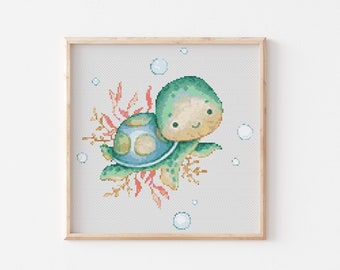 May include: A green and blue turtle with a smiling face swims through the water with coral and bubbles.