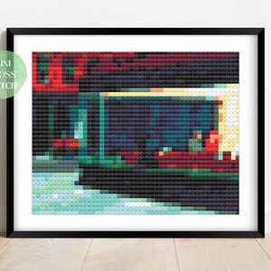 May include: A cross stitch pattern of a painting depicting a red building with a lit window at night. The building has a green awning and a sidewalk in front of it. Two figures are sitting at a table inside the building.