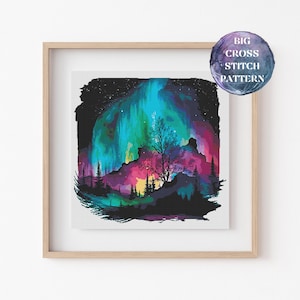 May include: A framed print of a colorful aurora borealis scene. The artwork features vibrant blues, greens, pinks, and purples, with a silhouetted tree and forest in the foreground. The text "BIG CROSS STITCH PATTERN" is on a circular sticker.