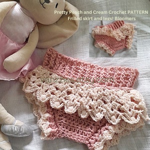 May include: Peach and cream crochet baby bloomers with a frilled skirt and legs. The bloomers are made with a delicate crochet pattern and have a soft, feminine look.