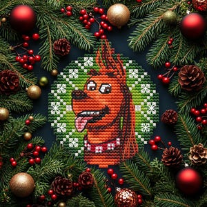May include: A Christmas ornament featuring a cartoon dog with a red collar, surrounded by a wreath of green and white snowflakes. The ornament is set against a backdrop of pine branches, red berries, and gold and red ornaments.