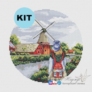 May include: A cross-stitch kit featuring a colorful illustration of a windmill, a small house, and a person with a backpack standing in a field. The kit includes a printed pattern and DMC floss.