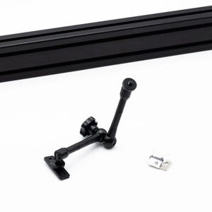 May include: Black adjustable camera arm with a ball joint and a 1/4-inch screw mount. The arm is attached to a black metal plate. A silver metal bracket is also included.