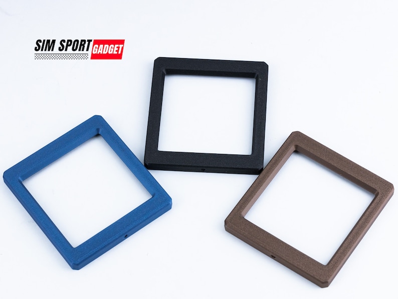 May include: Three square frames in blue, black, and brown. The frames have a textured surface and a square opening in the center. The text "SIM SPORT GADGET" is in the upper left corner.