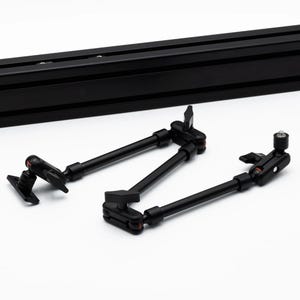May include: Two black adjustable camera arms with a swivel joint and a locking knob. The arms are attached to a black metal bar.