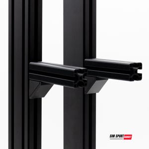 May include: Close-up of black metal brackets and supports. The image shows two vertical black metal supports with horizontal brackets attached. The brackets are designed to hold an item. The logo "SIM SPORT GADGET" is visible in the bottom right corner.