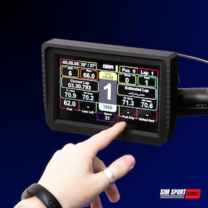 May include: A black digital display screen with various data readings, including speed, temperature, and lap times. The screen is being touched by a finger. The display is in a black frame. The text "SIM SPORT GADGET" is at the bottom right.