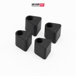 May include: Four black, matte-finished, triangular-shaped components with a single circular hole in the top surface. Each piece features a textured top and smooth sides. The text SIM SPORT GADGET is visible at the top of the image.