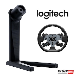 May include: A black Logitech racing wheel and stand are displayed against a white background. The racing wheel is black and gray with multiple buttons. The stand is black and has a vertical support with a circular mount.