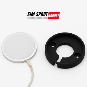 May include: A white round magnetic phone mount with a black base. The mount is connected to a white cable. The text "SIM SPORT GADGET" is visible in the top center of the image.