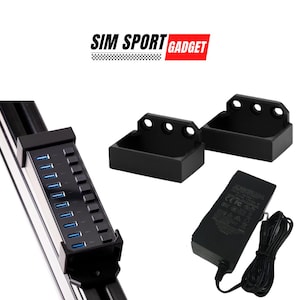 May include: A black USB hub with 10 ports, a black power adapter, and two black mounting brackets. The USB hub is mounted on a black metal rail. The text "SIM SPORT GADGET" is visible in the top center of the image.