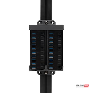 May include: A black USB hub with multiple ports and blue indicators is mounted on a black metal frame. The hub is rectangular with rows of ports. The image includes the text "SIM SPORT GADGET".