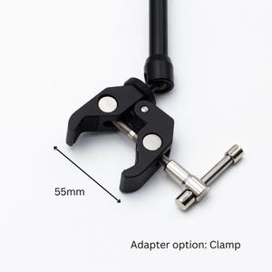 May include: Black clamp with a 55mm opening, a silver knob, and a black metal arm. Adapter option: Clamp.