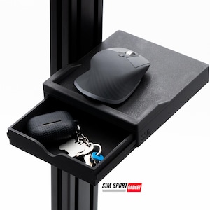 May include: A black metal desk stand with a drawer and a small shelf. The shelf has a black mouse on it. The drawer has a black case and keys inside. The stand has the text "SIM SPORT GADGET" on the front.