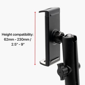 May include: Black tablet holder with adjustable arm and knob. The text on the image reads: Height compatibility: 62mm - 230mm / 2.5" - 9". The holder is designed to accommodate devices with a height between 2.5 and 9 inches.
