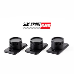May include: Three black plastic mounts with a circular knob on top. Each mount has a rectangular base with a hole in the center. The text "SIM SPORT GADGET" is visible above the mounts.