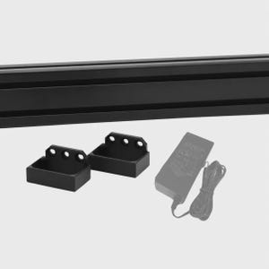 May include: A black aluminium extrusion profile bar, two black rectangular mounting brackets with three circular holes each, and a black power adapter with a coiled cord. The components are arranged together as a set of hardware parts.