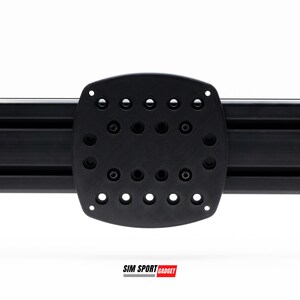 May include: Black plastic mounting plate with a grid of holes for attaching accessories. The plate is attached to a black aluminum track.