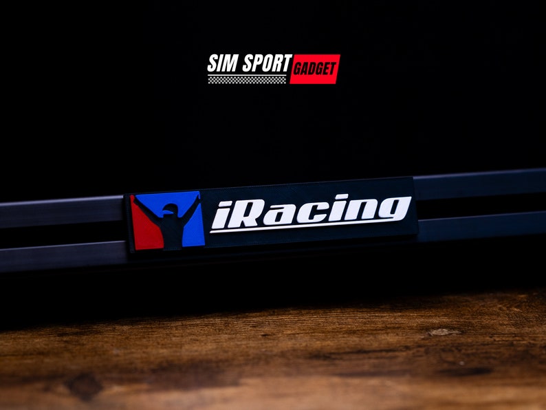 May include: A black and white iRacing logo with a red, white, and blue racing driver icon on a black background. The text "SIM SPORT GADGET" is above the logo.