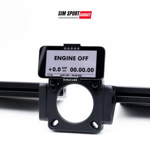 May include: A black Simucube racing simulator wheel mount with a black and white display showing "ENGINE OFF" and a timer reading "00.00.00".
