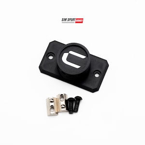 May include: Black rectangular mounting plate with a circular component featuring a white "U" logo. Includes silver metal brackets and black screws. The text "SIM SPORT GADGET" is in the top left corner.