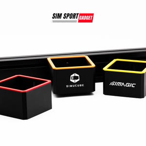 May include: Three black storage containers with colored trim, labeled "SIMUCUBE", "SIMMAGIC", and "SIM SPORT GADGET".